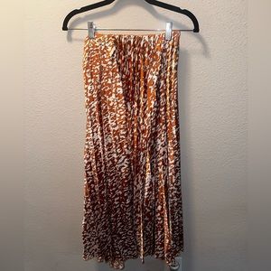 Long orange and white pleated skirt